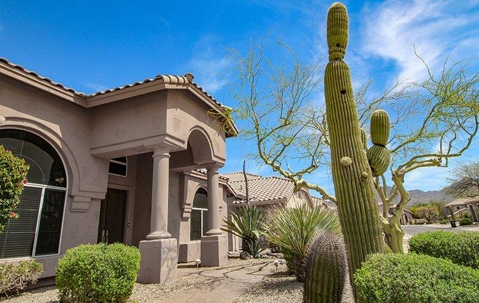 Mesa home with cactuses in the front yard.